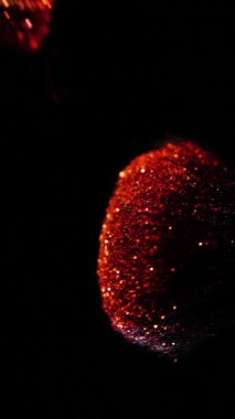 Vertical Screen: Makeup Brushes Touch Each Other on Dark Background and Small Particles of Cosmetics, Beauty Concept Super Slow Motion Content Shot for Social Media. High quality footage