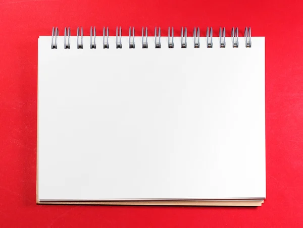 Top view of white blank note on red background