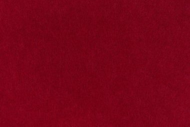 Burgundy, koyu kırmızı keçeli arka plan yumuşak bir kumaş yüzeyinin yakın çekimi. Kusursuz arkaplan, grafik tasarımı, yapıştırma kitabı, tekstil düzeni, yaratıcı projeler.