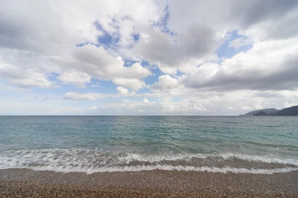 Beautiful sea paradise beach on a background of blue sky with clouds.