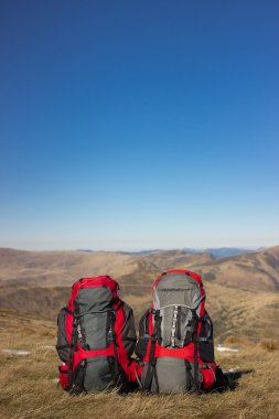 Sırt çantası dağlarda bir güneşli yaz günü kamp.