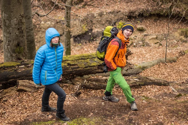Chłopak i dziewczyna spaceru w lesie piękne z plecakiem. — Zdjęcie stockowe