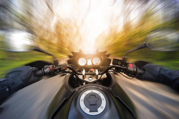 Mãos no volante enquanto conduz uma moto à velocidade . — Fotografia de Stock