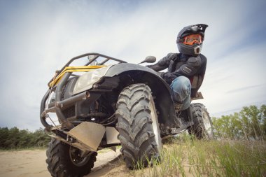 Racing ATV is sand. clipart