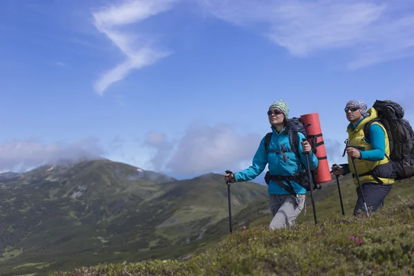 Summer hiking in the mountains with a backpack .