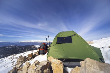 Dağlarda bir sırt çantası ve çadır kamp kış.