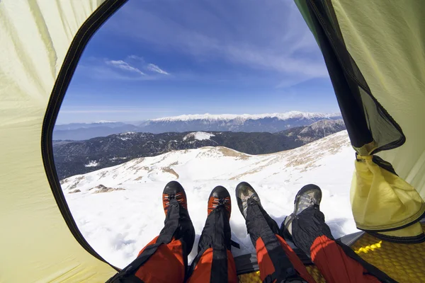 Winter camping in the mountains with a backpack and tent.