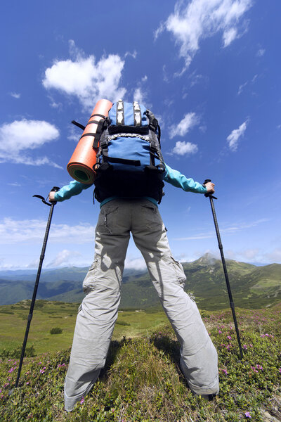 Summer hiking in the mountains with a backpack . 