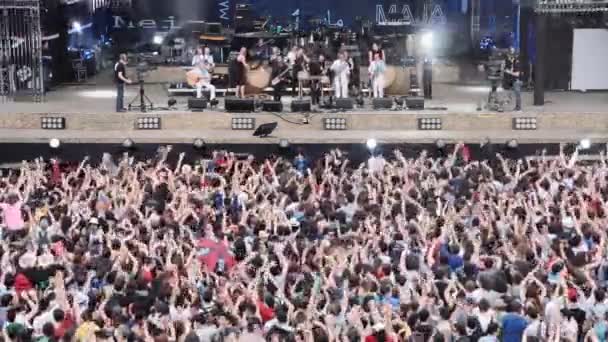 Roma, Italia, 1 de mayo de 2015- Gente viendo un concierto bajo la lluvia frente al escenario: Roma, 1 de mayo — Vídeos de Stock