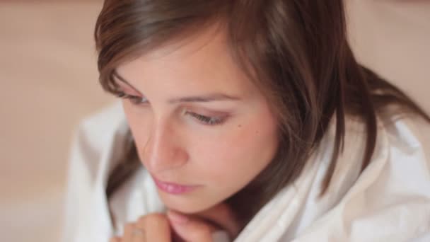 Depressed young woman sitting on the bed — Stock Video