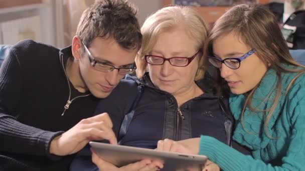 Family on tablet pc at home on couch — Stock Video