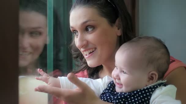 Happy young mother playing with baby girl at home — Stock Video