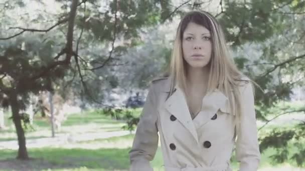 Serious beautiful girl walking in the park — Stock Video