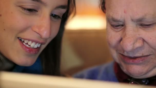 Young woman teaches her grandmother work with computer - senior lifestyle — Stock Video