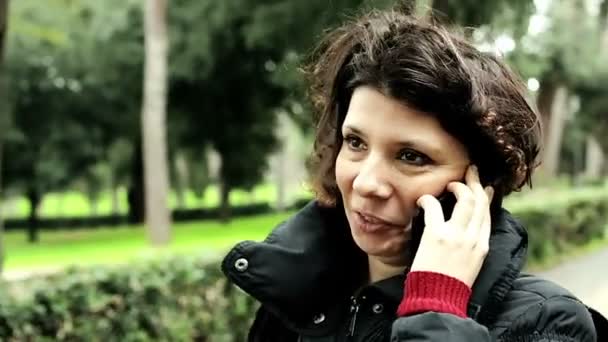 Kadın yürüyor ve cep telefonunuzun konuşma — Stok video