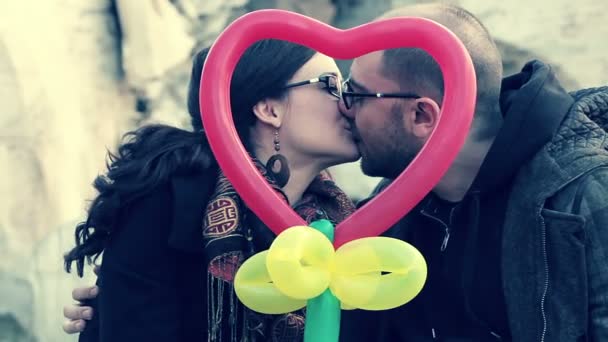 Young couple outdoor portrait. They holding big red harts — Stock Video