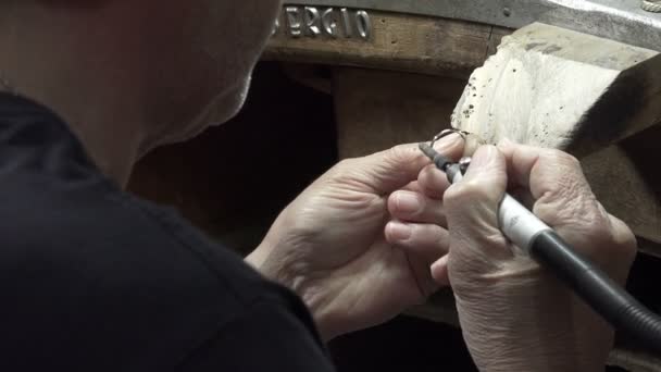 Goldsmith processing golden and silver objects — Stock Video