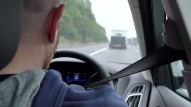 Genç adam araba kullanıyor. 