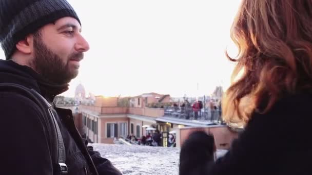 Two young people looking at the roofs of Rome at the sunset — ストック動画