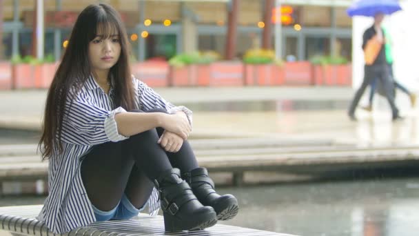 Sad chinese woman sitting alone — Stock Video