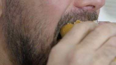bir adam yeme hamburger portre görüntüleri: onun dudağında belirli