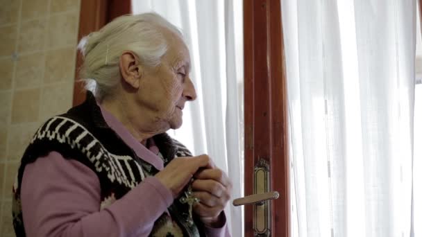 Vecchia donna che prega alla finestra: dio, religione, anziani, fede, nonna, preghiera — Video Stock