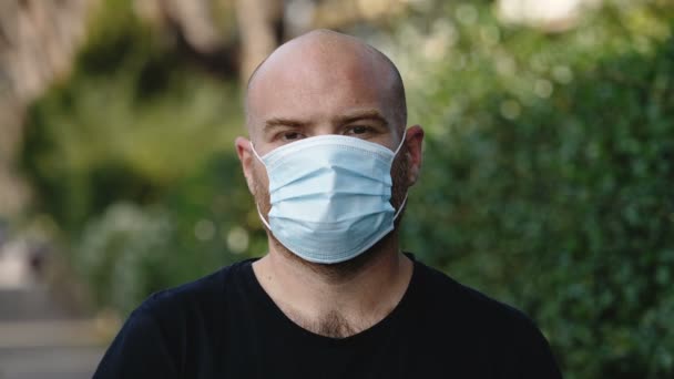 Coronavirus Πανδημία Νεαρός Σκεπτικός Άνθρωπος Φορώντας Μάσκα Κοιτάζει Την Κάμερα — Αρχείο Βίντεο