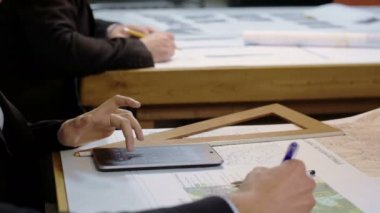 Stüdyo çalışması mimar: haritalar ve planlar üzerinde çalışan insanlar