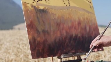 ressam bir buğday alan ortasında