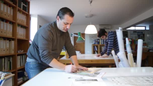 Design studio, (dolly)two architects working on a project — Stock Video