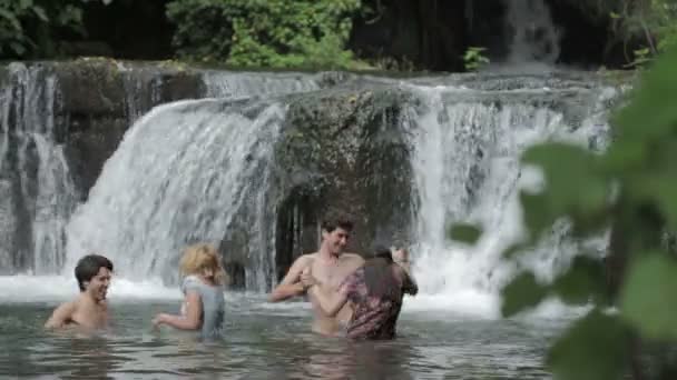 Girls of boys have fun in a river - dancing, hugging and playing with water — Stock Video