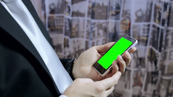 Businessman using smartphone with green screen — Stock Video