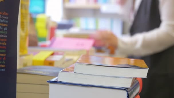 Woman searching for a book — Stock Video