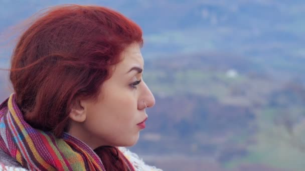 Depressed woman on top of a mountain, the wind off his hat — Stock video