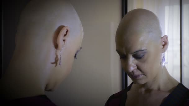 Раковая женщина смотрит в зеркало: одиночество, грусть, уныние — стоковое видео