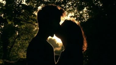 ihale gün batımında kisses: siluet içinde çift öpüşme