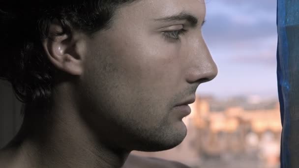 Pensive young man near the window — Αρχείο Βίντεο