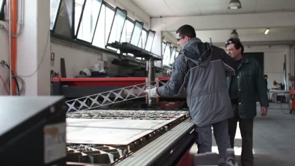 Due operai che progettano il lavoro in una fabbrica - dolly — Video Stock