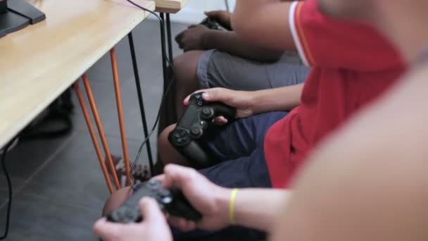 Boys use controllers to play video game — Stockvideo