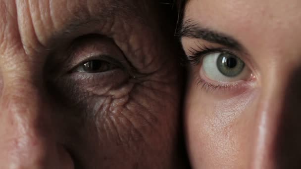 Eyes - Grandmother and granddaughter looking together at camera. Close up — Stock video