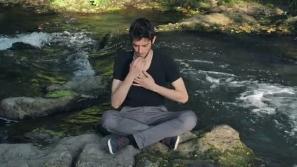 Man praying near the river — Stock Video