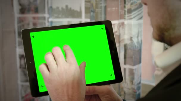 Young man typing on a tablet computer: green screen, alpha channel — Stock video