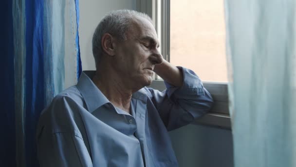 Viejo hombre deprimido en la ventana: tristeza, soledad, depresión — Vídeos de Stock