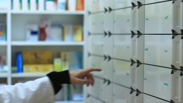 Pharmacist taking medicines from the drawer — Stock Video