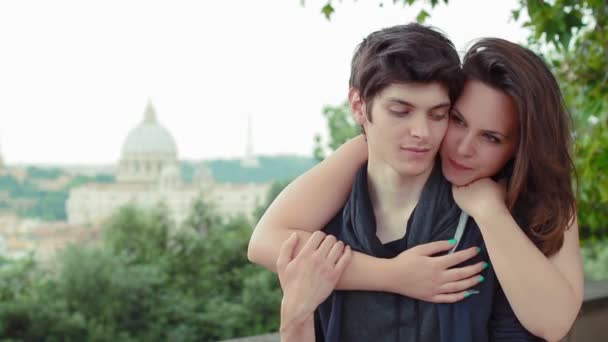 Embracing couple laughing and joking - saint peter in background — Stock Video