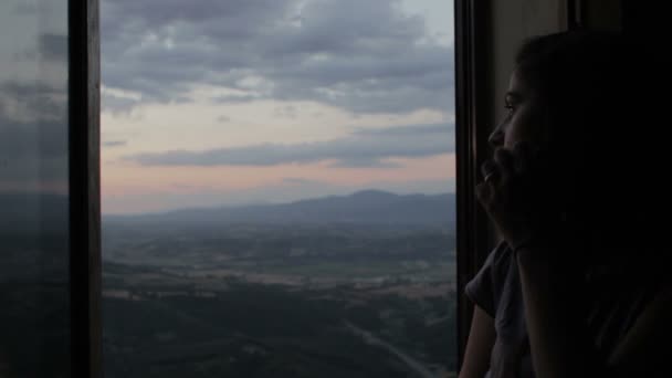 Woman in love looks a wonderful landscape from her window — Stockvideo