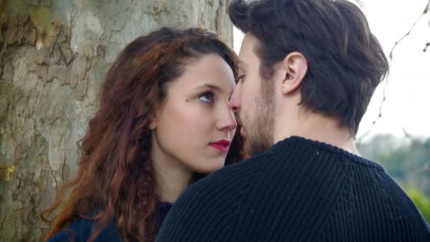 Couple in love: man kisses a beautiful young woman: falling in love — Stockvideo