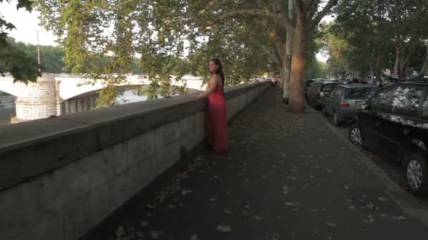 Sad and pensive girl with red dress at sunset - steadycam — Stock Video