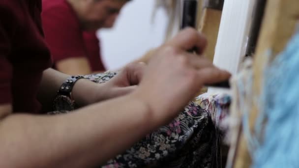 Elderly woman working at weaving an Oriental rug: persian rug — Stock Video