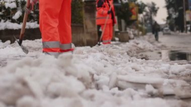 Kaldırım temizlemek için kar kürekle erkekler